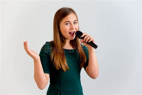 Girl Singing with a Microphone Stock Photo - Image of performer ...