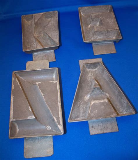 Cladder & Jansen - Set of 4 old chocolate letter moulds. - Catawiki