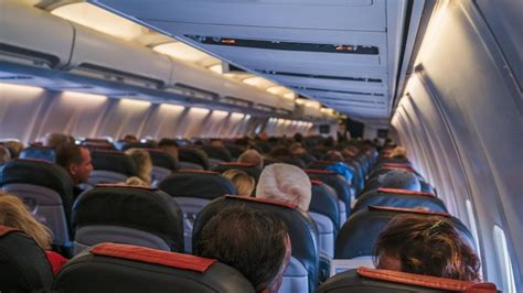 Premium Photo | The rear view of the many people on the plane interior of airplane with ...