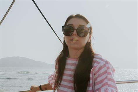 Premium Photo Portrait Of A Beautiful Brunette In Sunglasses On A Boat