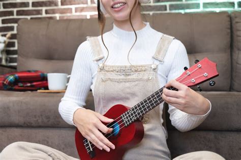 Ukulele In Female Hands Learning To Play The Ukulele Close Up The