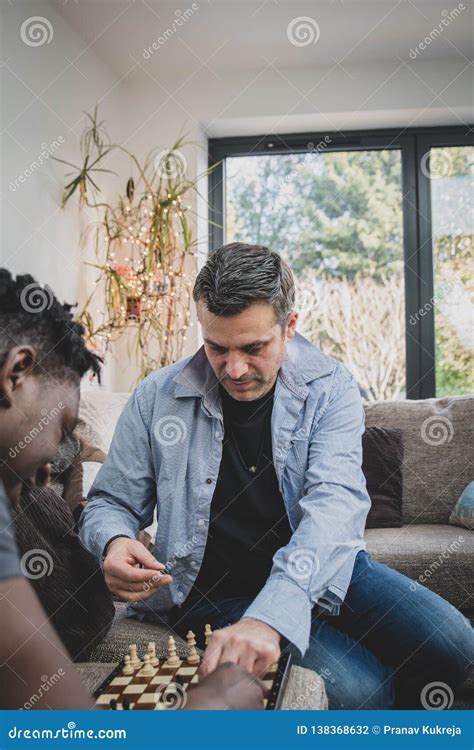 A Gay Couple Enjoying Time Indoors At Home Playing Chess Stock Photo Image Of Married Night