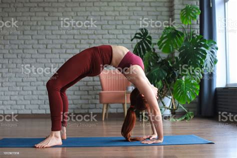 Attractive Woman Practicing Yoga Standing In Bridge Exercise Urdhva