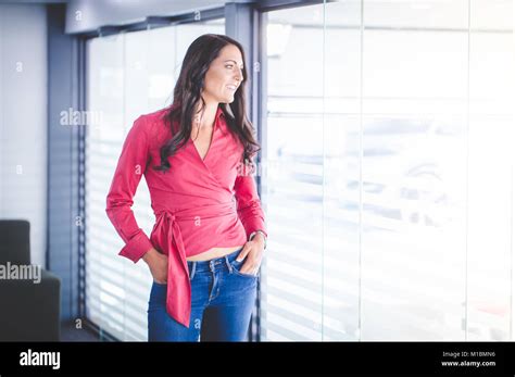 Beautiful Brunette Business Woman Standing In A Boardroom Stock Photo
