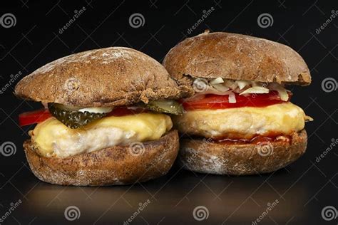 2 Juicy Burgers With Vegetables And A Large Chicken Cutlet In Dark