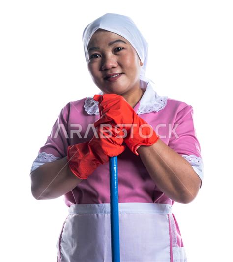 Portrait Of A Cleaning Lady Wearing Gloves And Apron Holding A Hand Broom Chores And Chores