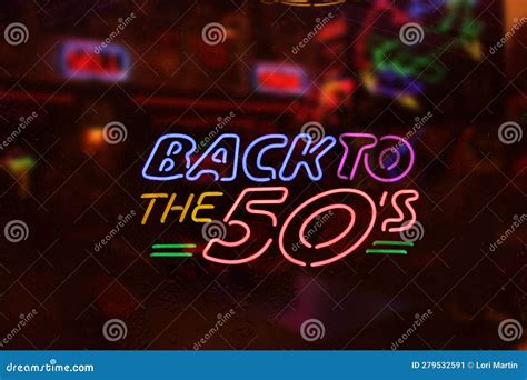 Vintage Neon Back To The 50s Sign In Rainy Cafe Window Stock Image