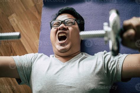 Young fat man workout with dumbbell 17324477 Stock Photo at Vecteezy