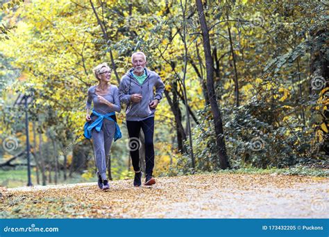 Old Couple Of Pensioners Running In Park Stock Image Image Of Healthy