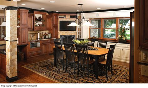 a dining room table and chairs in a kitchen with wooden cabinets, hardwood floors and an area ...