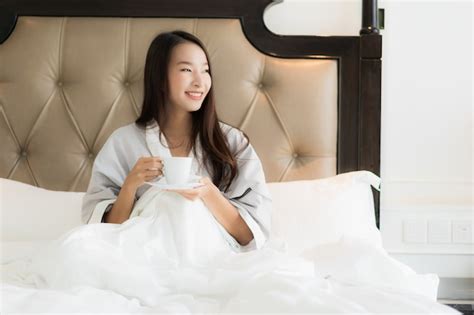 Free Photo Portrait Beautiful Young Asian Woman Wake Up With Happy Smile And Coffee Cup On Bed