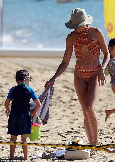 Rachael Finch Sizzles In Orange Bikini As She Hits The Beach With Her