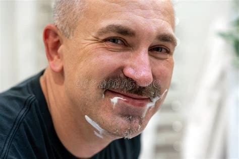 Middle Aged Handsome Man Shaving His Beard In Bathroom Stock Image