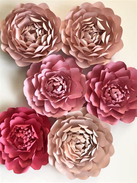 Pink Paper Flowers Arranged On A White Surface