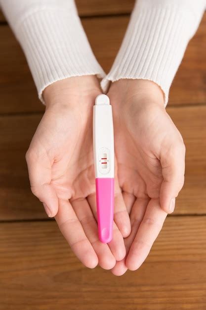 Premium Photo Woman Hands Holding Positive Pregnancy Test