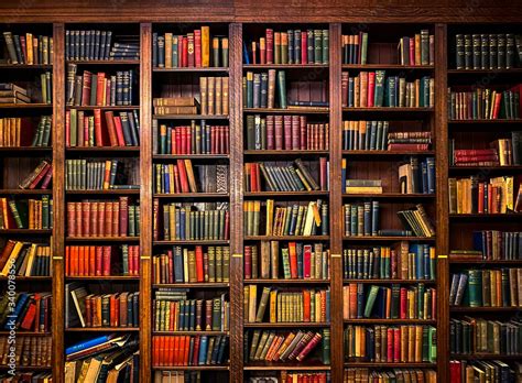 Books On Shelves In Library Or Study With Classic Dark Wood Stock Photo