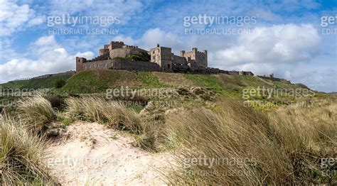 Landscape Panorama Of Bamburgh Castle And Sand Dunes In Northumberland