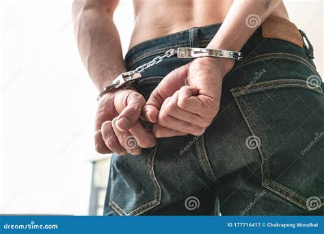 Man With His Back Hands Handcuffed In Criminal Concept Stock Image