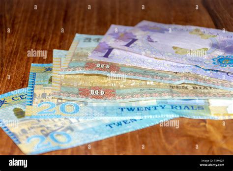 The Riyal Currency of the Oman notes spread out on the table. Money ...