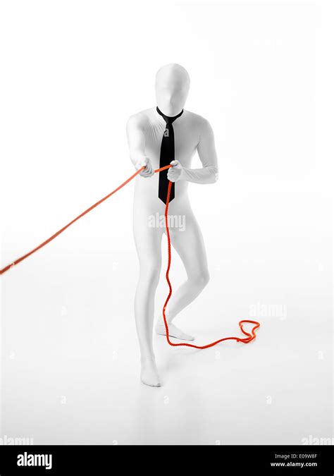 Faceless Businessman With Black Tie Pulls An Orange Rope Stock Photo