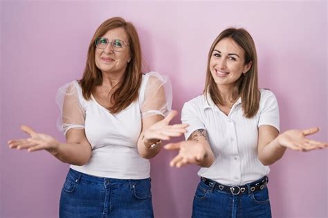 Premium Photo Hispanic Mother And Daughter Wearing Casual White T Shirt Over Pink Background