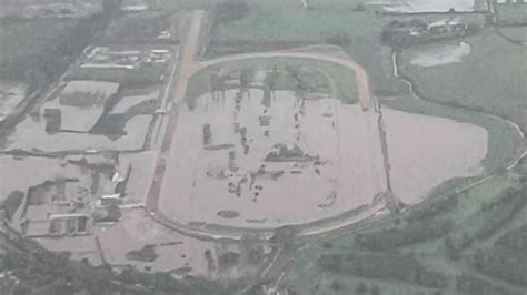 Racecourse left underwater after deadly Storm Babet breaches flood defences and causes mass ...