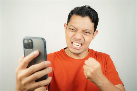 Premium Photo Asian Man In Orange Tshirt Looks Excited Or Spirit