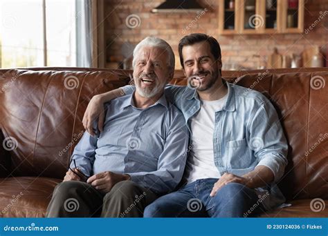 Portrait Of Happy Mature Father With Grownup Son Hugging Stock Photo