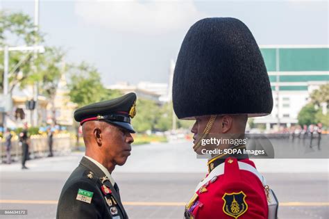 An officer of the Thai Royal Army checks a soldier's uniform ahead of ...