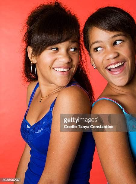 75 Portrait Of Smiling Twin Sisters Back To Back Stock Photos High Res