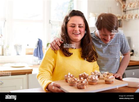 Portrait Of Downs Syndrome Couple Decorating Homemade Cupcakes With