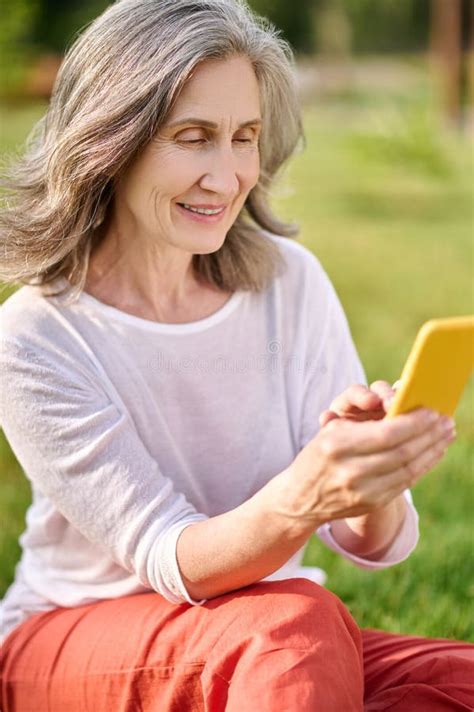 Adult Woman In Casual Clothes With Smartphone Outdoors Stock Image Image Of Lawn Wellbeing