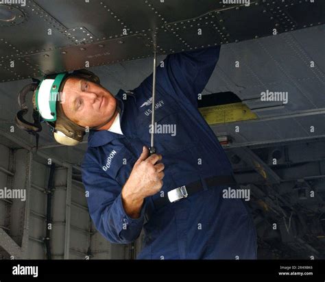 US Navy Aviation Structural Mechanic 1st Class Replaces A Panel On A MH