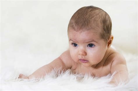 Newborn Baby Girl Lying On Sheepskin Stock Photo