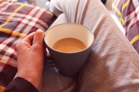 Premium Photo Midsection Of Person Holding Coffee Cup On Lap