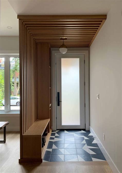 An Entry Way With A Bench And Wooden Paneling On The Wall Next To A