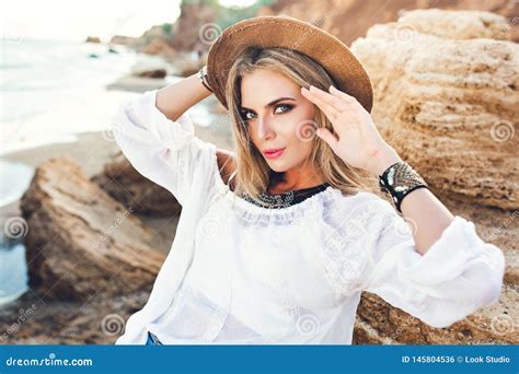 Horizontal Portrait Of Attractive Blonde Girl With Long Hair Posing To The Camera On Deserted