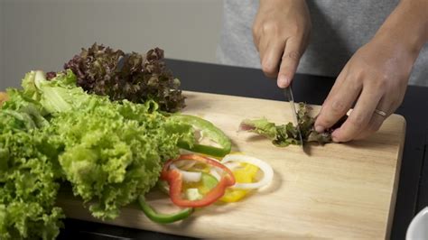 Premium Photo Woman Cutting Fresh Salad Vegetable For Making Salad