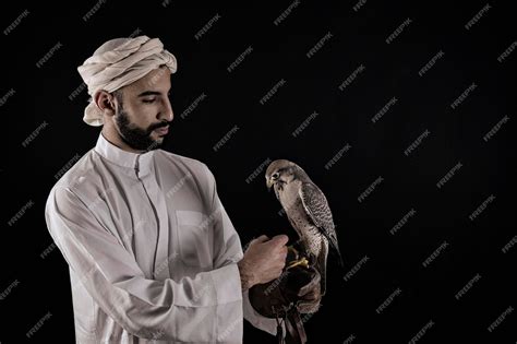 Premium Photo Young Arab Prince Holding A Bird Of Prey