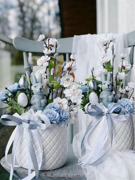 Two White Baskets Filled With Blue And White Flowers