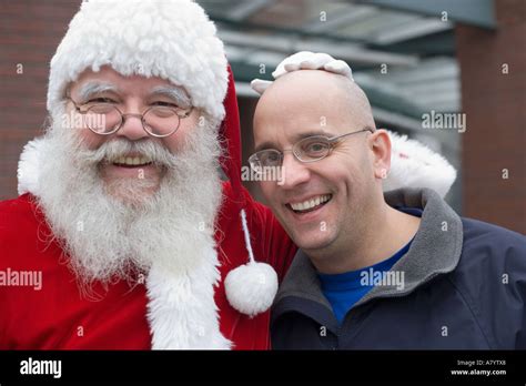 santa Claus poses with bald headed man Stock Photo - Alamy