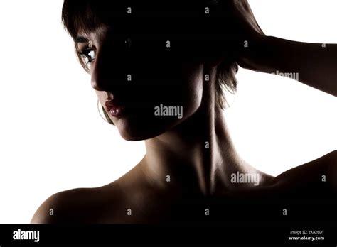 Silhouette Studio Portrait Of A Beautiful Brunette Girl With Short Hair Against White Background