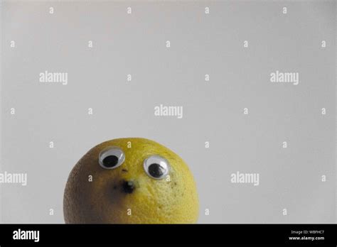 Lemon With Eyes And Nose Over White Background Stock Photo Alamy