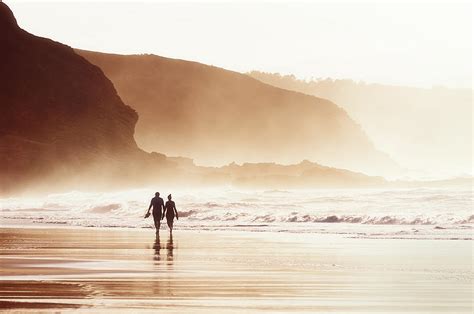 Couple Walking On Beach With Fog Photograph By Mikel Martinez De Osaba