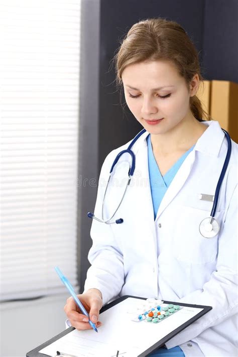 Woman Doctor At Work At Hospital Young Female Physician Write