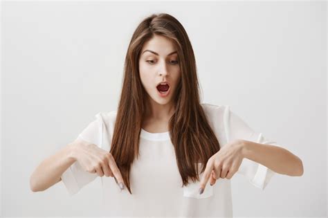 Free Photo Astounded And Surprised Attractive Woman Pointing Down Drop Jaw Astonished