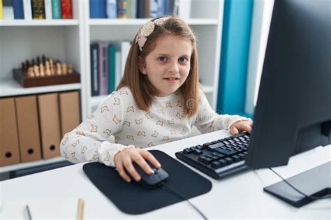 Adorable Blonde Girl Student Using Computer Sitting On Table At Classroom Stock Image Image Of