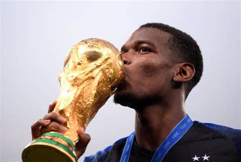 Paul Pogba Of France Celebrates Victory By Kissing The World Cup Trophy