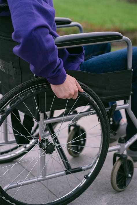 Person Pushing a Wheelchair · Free Stock Photo