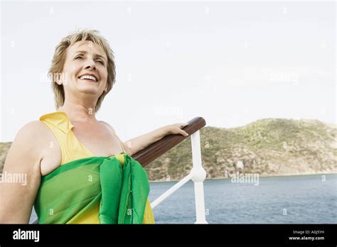 Mature Woman Standing At The Railing Of A Sailing Ship And Smiling Stock Photo Alamy